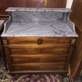 Antique bedroom suite from France late 1700s. Includes washstand with gray marble top, headboard and footboard, wardrobe, and small square table with gray marble top.