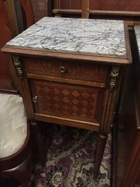 Antique bedroom suite from France late 1700s. Includes washstand with gray marble top, headboard and footboard, wardrobe, and small square table with gray marble top.