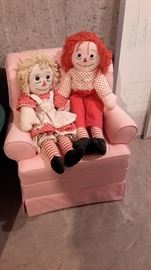 Handmade Raggedy Ann and Andy sitting on pink wing back chair.