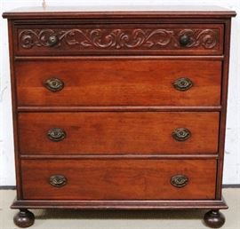 Intricately carved chest on bunn feet