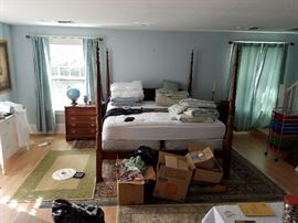 Four Poster Bed with Wheat Design Posters - Two Broyhill Bedside Chests of Drawers. Large Persian Style carpet (under bed). Small Grass Woven Carpet on Left. 