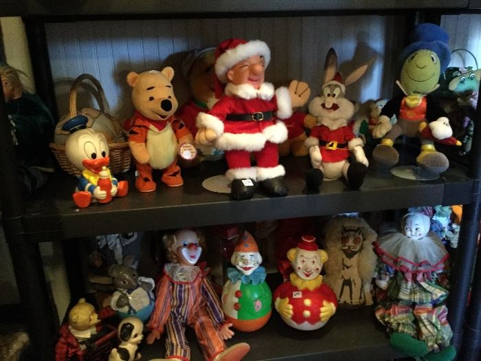 Collection of character dolls and clowns.