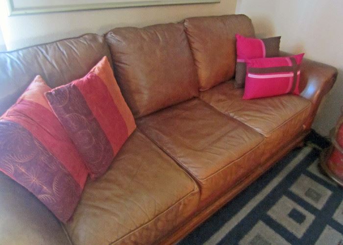Brown leather sofa and decorator pillows
