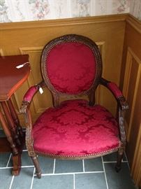 One of two matching antique parlor chairs