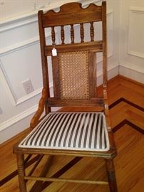 Striped upholstered antique rocker has a matching fabric settee