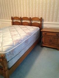 One of two twin beds; nightstand