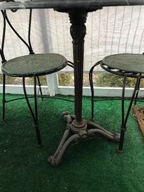 CAST IRON MARBLE TOP TABLE AND TWO CHAIRS