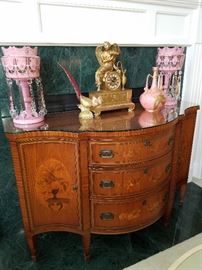 Widdicomb at its best.  Beautifully inlaid serpentine front cabinet, floral marquetry in exotic woods