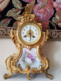 Gilt bronze French clock with scenic porcelain sets. Insets are probably Limoges.  Clock not working.