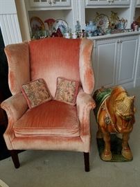 Wingback chair and ceramic horse figure