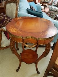 One of a pair of these inlaid mahogany tables with metal accents