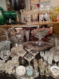 Pressed and cut glass.  Note more stemware on upper shelf