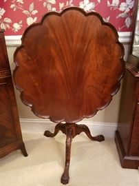 Tilt-top lobed piecrust edge table with flame mahogany top.