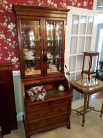 Hekman barrel or cylinder desk/secretary. Coromandel style carved stone wreath setting on leather pull-out writing surface.  Lighted upper mirror back display