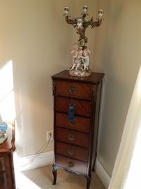 Dresden style candelabrum on a John Widdicomb 6 drawer lingerie chest with ormolu mounts. Stunning piece.