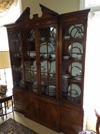 Broken Arch style breakfront with 4 doors having Gothic style arched mullions.  Per Gordon Wassenaar, this is a Baker Furniture Company piece