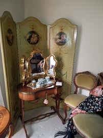 Baker kidney shaped table in front of a painted canvas covered folding screen