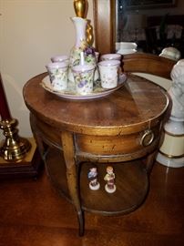 This is a miniature (shown on top of the dresser) with mini Hummel-type figures and diminutive beverage set