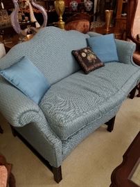 Sofa/Settee in camel back variation. Carved legs in the Chippendale style
