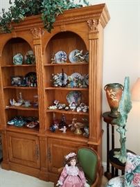 Cabinet in living room is displaying numerous decorative items.  Cabinet itself is Not For Sale, but has remained in the home for display purposes.  Roseville vase has a base chip