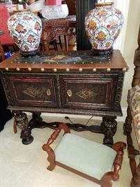 Ca. 1920 Spanish style cabinet with painted leather top. Cloisonne vases both with damage.  Cute foot stool may be a Carl Forslund piece