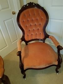 Victorian walnut arm chair with porcelain casters.