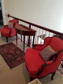 Pair of red tone upholstered chairs.  Demilune table by Irwin (Grand Rapids)  Table is a card/games table and the top flips open to make a round table. The back legs swing out to support the top when open
