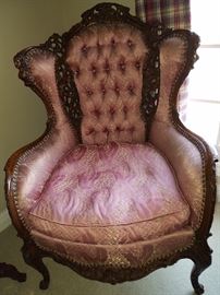 Ornate wingback chair with pierce carving, and a down cushion on the seat