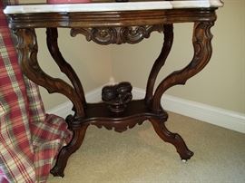 Close up of marble top walnut table