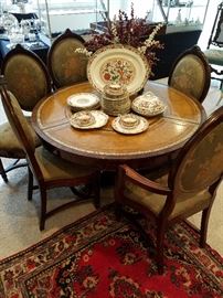 Round table with a set of 6 medallion back chairs (two with arms).