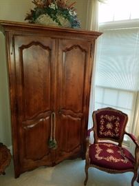 Armoire by Ethan Allen (part of the Ethan Allen bedroom suite in this master bedroom), Needlepoint upholstered arm chair