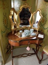 Triple gilt mirror.  White square on the table is the original hang tag from Baker Furniture Company