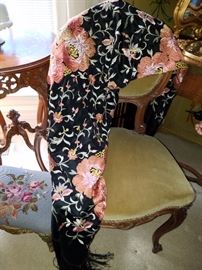 Embroidered silk shawl on one of a pair of Victorian style chairs