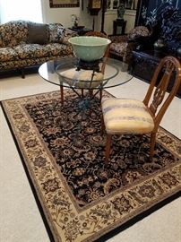 Oriental style rug, pair of chairs, and glass top table.  Base in the form of 3 arrows....patinated