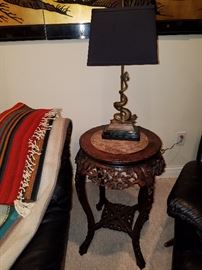 Carved stand with marble inset.  Dolphin form table lamp