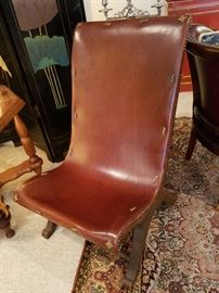 Leather 'sling' chair with brass accents.  