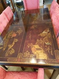 Oriental design dining table that has two additional leaves (in original box) and pads.  No maker's label found.  Shown with set of 8 damask upholstered chairs with down seats.