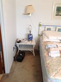 Wicker side table.  Lamp needs rewiring , radio, sound box bed linens