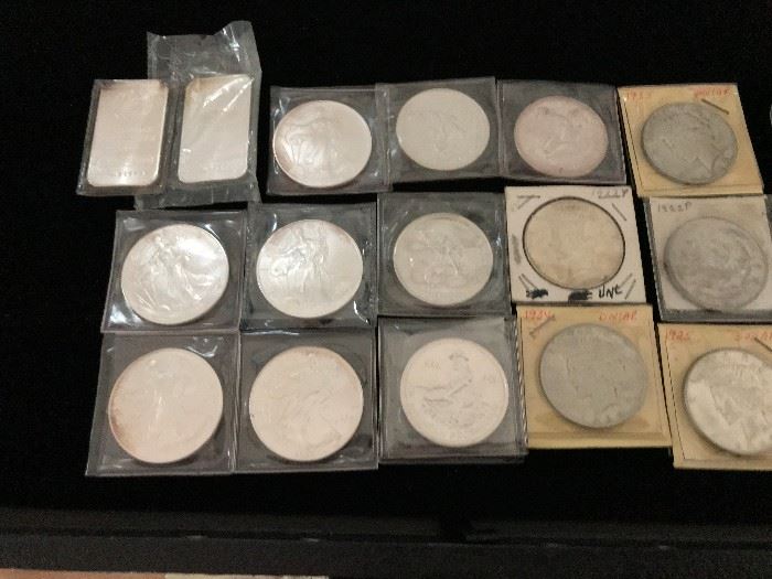 2 one ounce silver bars, 4 one ounce Liberty rounds, 5 Piece dollars, 4 other one ounce coins 