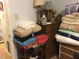 Bedding, chest of drawers, and lamps