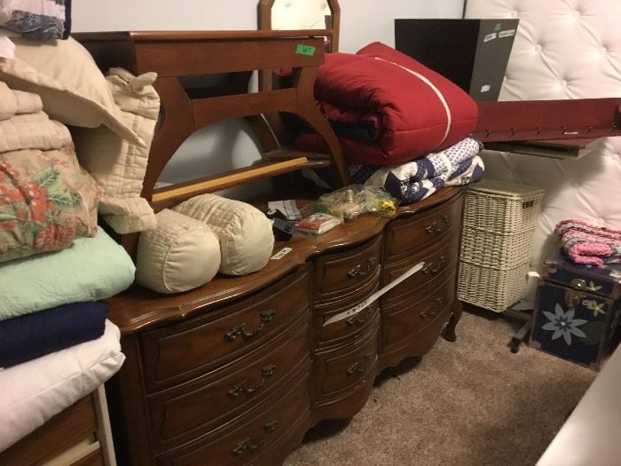 Dresser, more bedding, piano bench (on top of dresser), wicker clothes basket and more