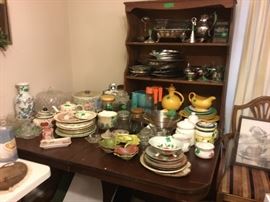 Both glass and silver items in dining room + dining room table & chairs