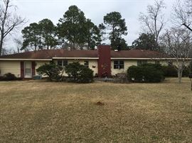Rear of 4 bedroom, 2 1/2 bath home built in 1963; with two-car carport; large office and laundry room.  .76 corner acre lot with large private patio.