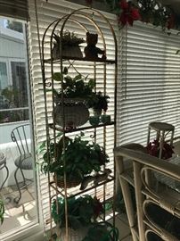Tall, brass arched shelves with four glass shelves