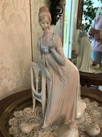 Lladro "A Lady Of Taste", woman holding flowers with chair & book, figurine #1495