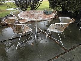 This wrought iron patio set just needs fresh paint.