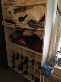 This is a view of the towels for sale along with woman's shoes and some sweaters.