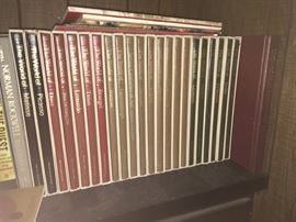 There are two wall units of books -- these are a set of art books.