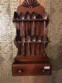 This is a set of vintage spoons complete with display rack.