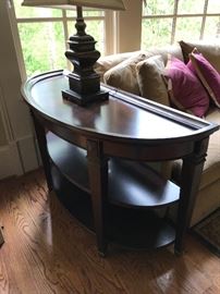 A demilune sofa table - put this behind your couch and wait for the compliments!